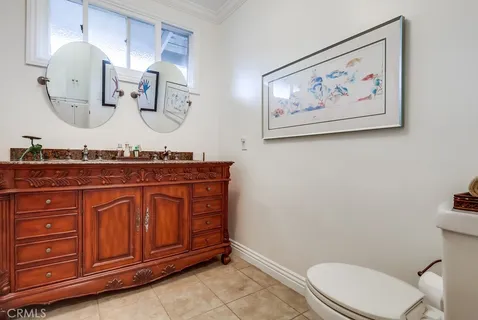 a bathroom with a toilet a sink and a mirror