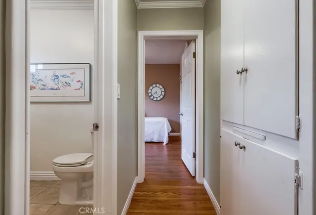 a bathroom with a toilet and a view of bathroom