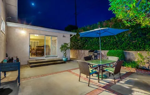 a view of an outdoor sitting area with furniture and umbrella