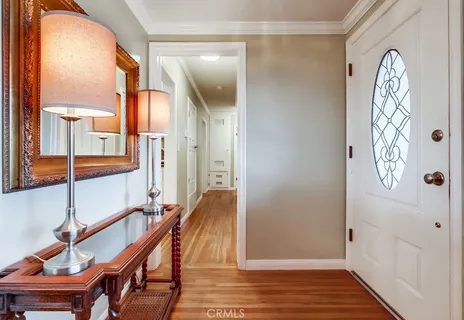 a view of an entryway with wooden floor and a door
