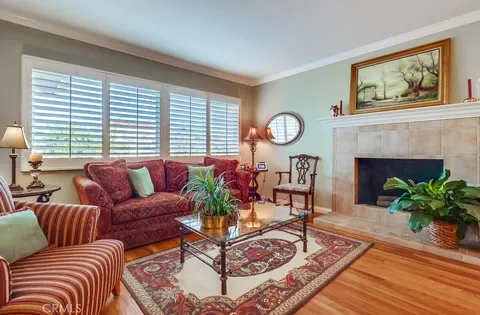 a living room with furniture a fireplace and window