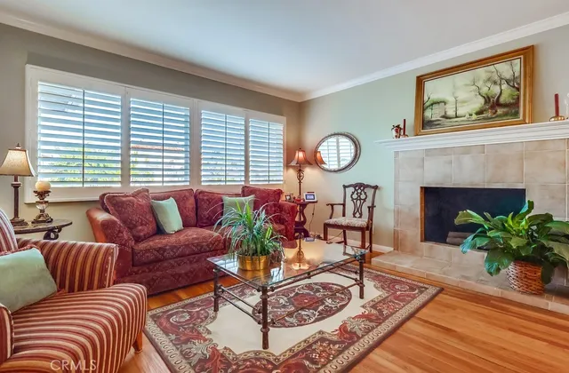 a living room with furniture a fireplace and window