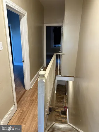 an empty room with wooden floor and closet