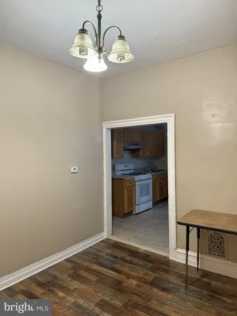 a view of a room with wooden floor and a window