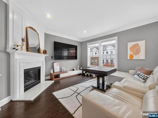 a living room with furniture a fireplace and a flat screen tv