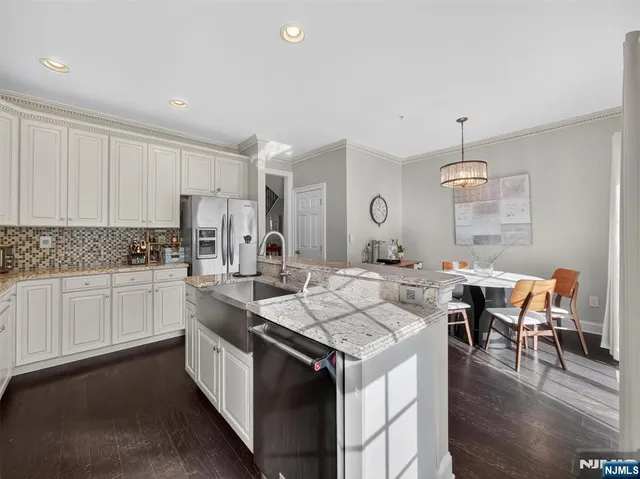a kitchen with a table chairs stove and cabinets