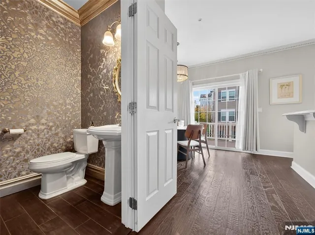 a bathroom with a toilet a sink and a window