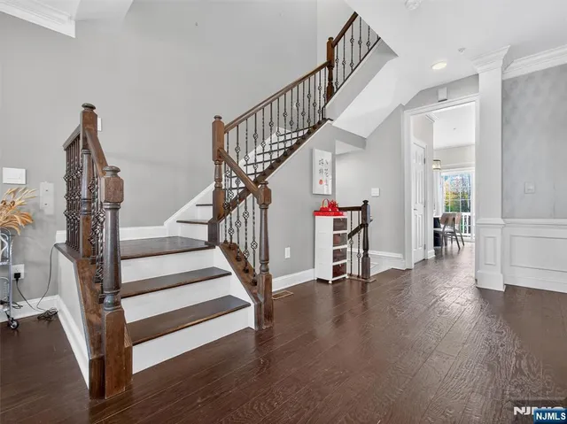 a view of entryway with wooden floor and stairs