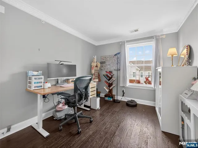 a view of a workspace with furniture and a window