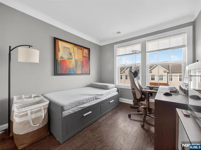 a bedroom with a bed and a desk