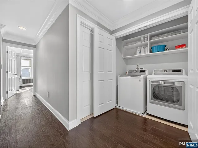 a view of washer and dryer with wooden floor