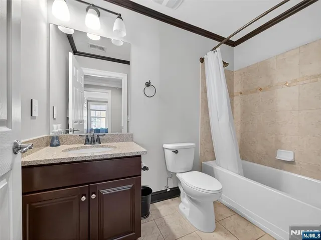 a bathroom with a sink toilet tub and shower