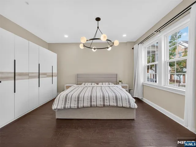 a spacious bedroom with a bed and a window