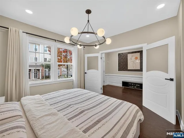 a bedroom with a large bed and a large window