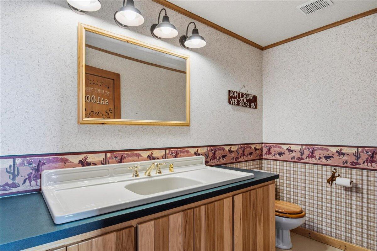 11182 Southwest Dynamite Lane Culver, OR 97734 - Photo 50 of 70 a bathroom with a sink a toilet and a mirror