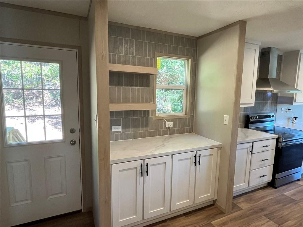 2860 Camp Road Jasper, GA 30143 - Photo 19 of 19 a kitchen with white cabinets and wooden floors