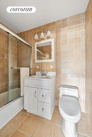 a bathroom with a granite countertop sink a toilet and shower