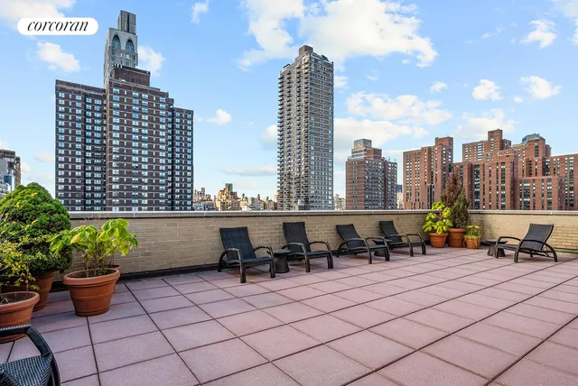 a terrace with outdoor seating and city view
