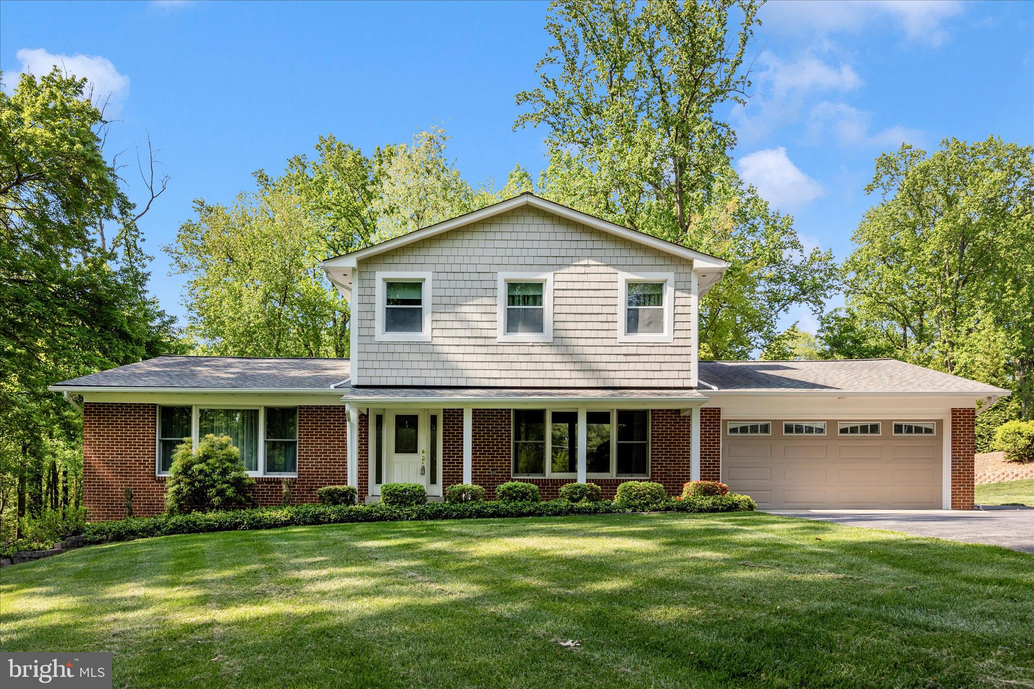 a front view of a house with a garden and porch