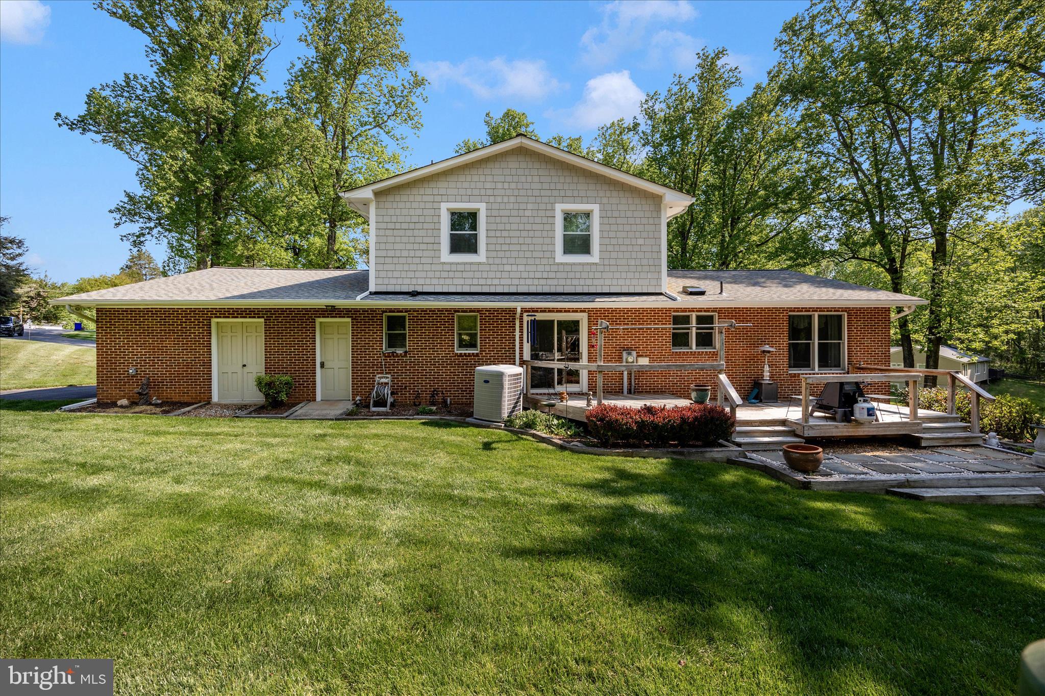 13949 Brighton Dam Road Clarksville, MD 21029 - Photo 2 of 27 a front view of a house with a garden and patio