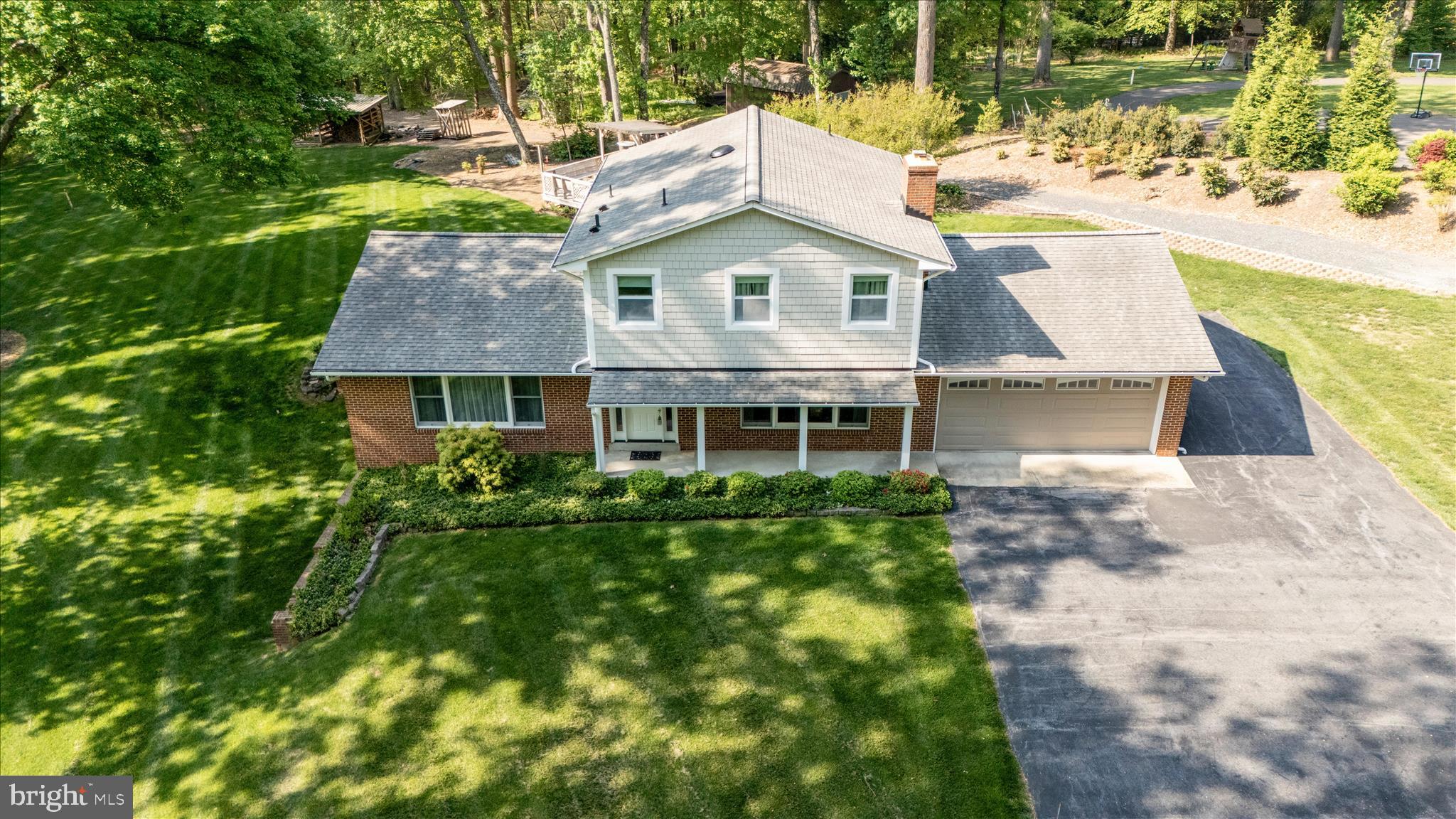 13949 Brighton Dam Road Clarksville, MD 21029 - Photo 7 of 27 a aerial view of a house with a yard table and chairs