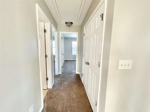 a view of a hallway with a wooden door