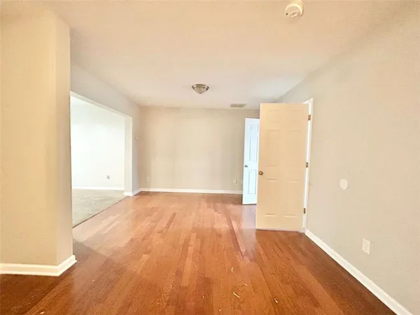 a view of an empty room and wooden floor