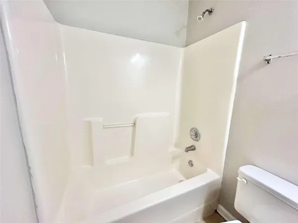 a bathroom with a bathtub and a toilet