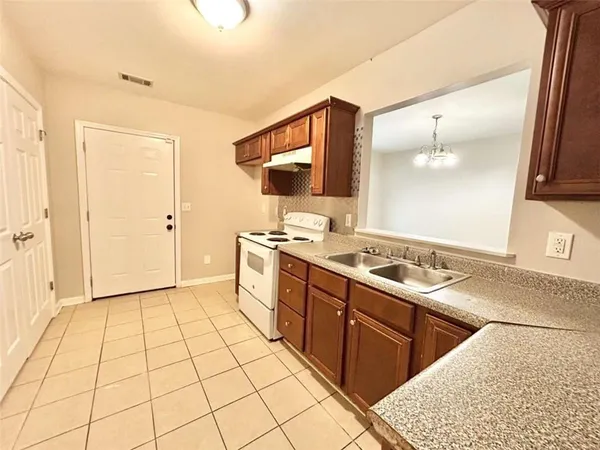 a large kitchen with a sink and cabinets
