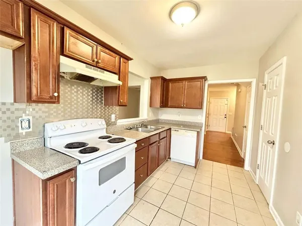 a kitchen with a stove sink and a refrigerator