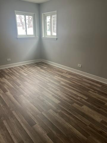 8741 South Cottage Grove Avenue, Unit 1E Chicago, IL 60619 - Photo 4 of 6 a view of an empty room with wooden floor and a window