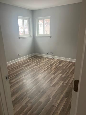 8741 South Cottage Grove Avenue, Unit 1E Chicago, IL 60619 - Photo 5 of 6 a view of empty room with wooden floor