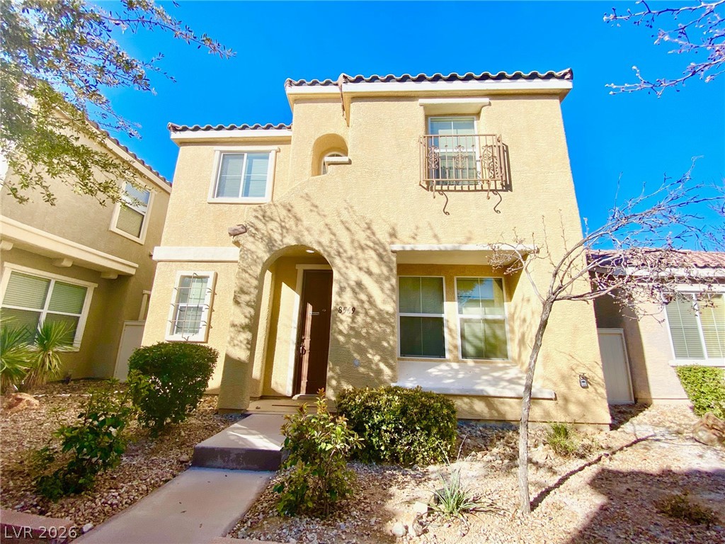 8569 Rhamus Court Las Vegas, NV 89149 - Photo 1 of 35 A terracotta-tiled roof crowns this appealing stucco home, featuring a charming Juliet balcony and arched entry.