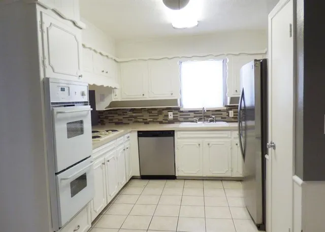 a kitchen with a stove and refrigerator