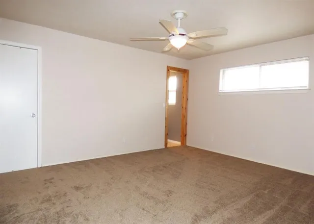 a view of a livingroom with a ceiling fan and a ceiling fan