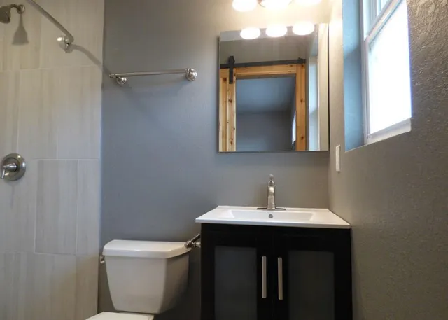 a bathroom with a toilet and a shower