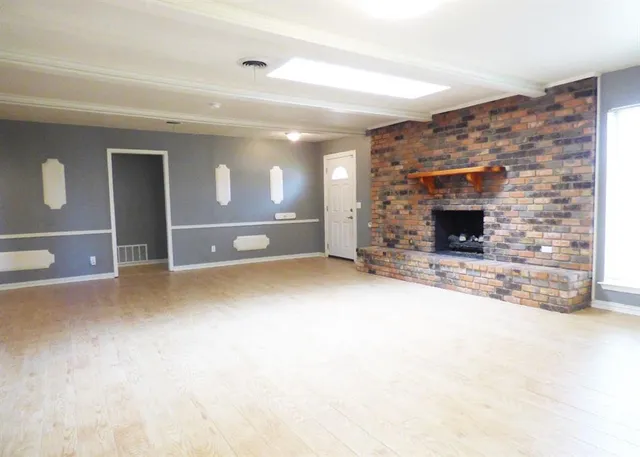a view of empty room with a fireplace