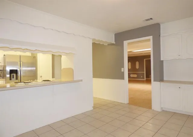 a view of a kitchen with wooden floor and a window
