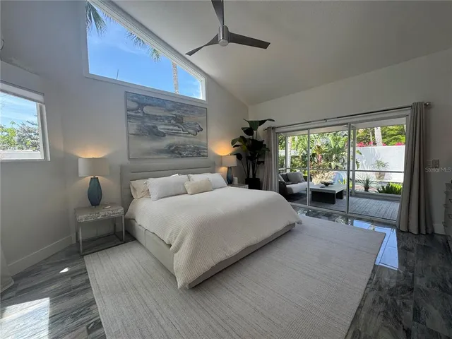 a bed room with a bed and a large window