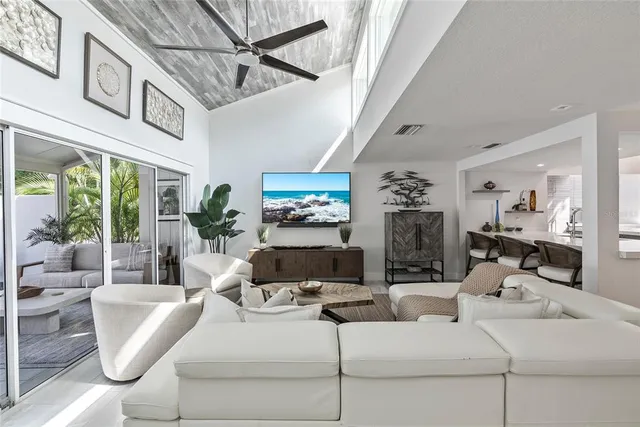 a living room with furniture a chandelier and a fireplace