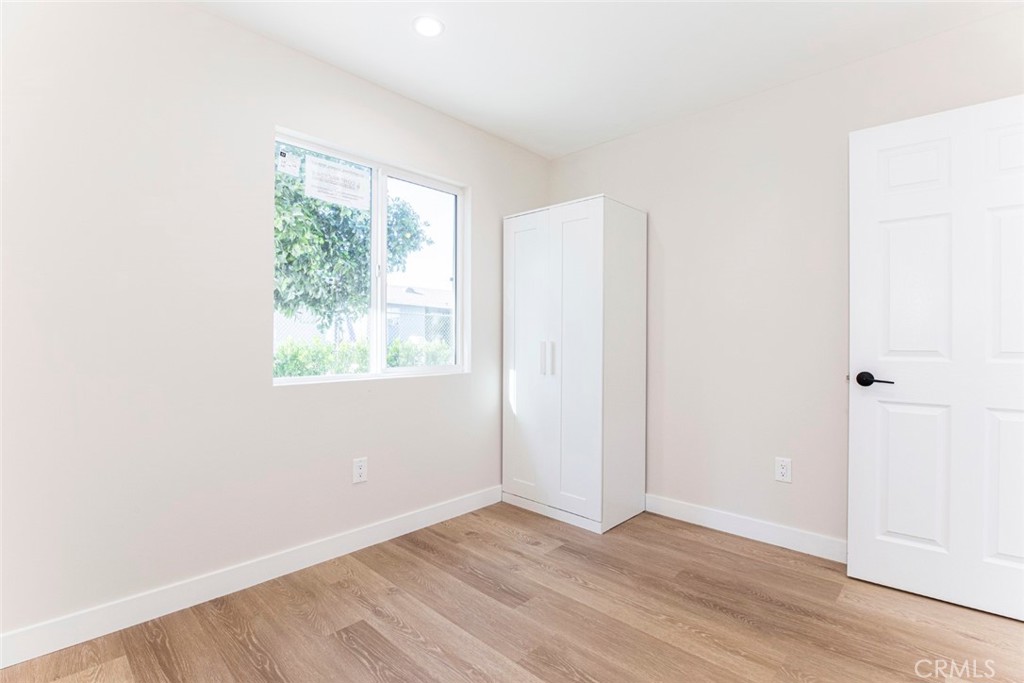 8879 Morehart Avenue Sun Valley, CA 91352 - Photo 12 of 13 an empty room with wooden floor and windows