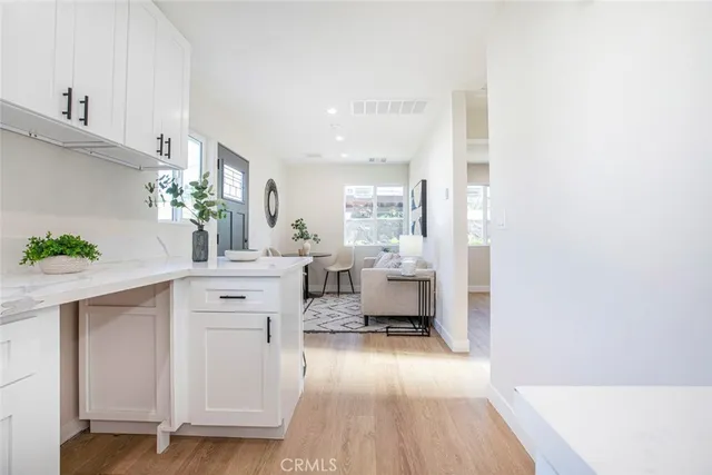 a kitchen with white cabinets and counter space