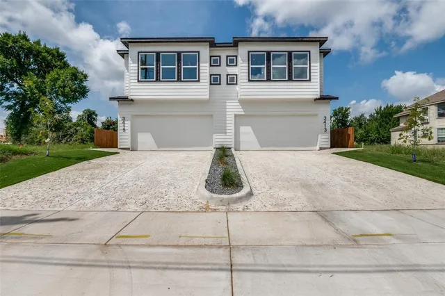 a white house with yard in front of it