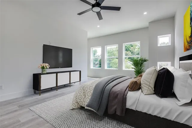 a bedroom with a bed and a flat screen tv