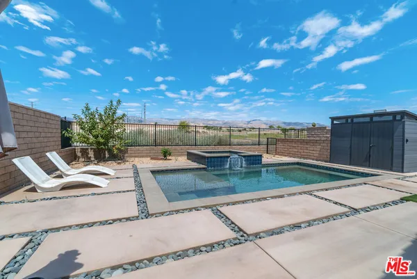 a view of a backyard with sitting area