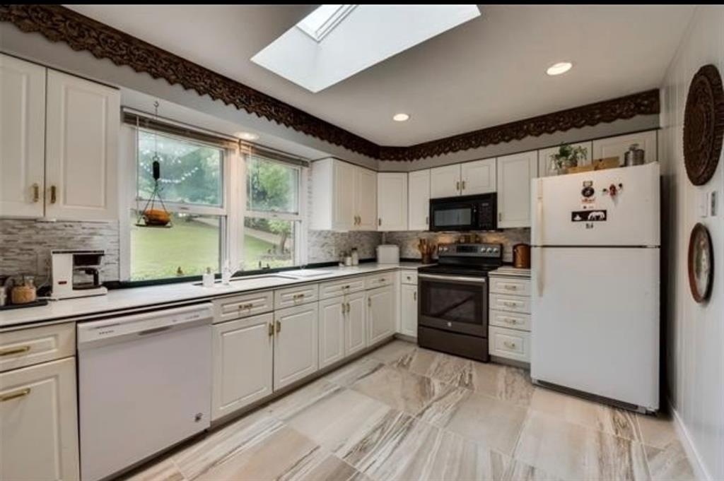6049 West Red Bird Lane Dallas, TX 75236 - Photo 12 of 34 a kitchen with granite countertop appliances a sink and a microwave