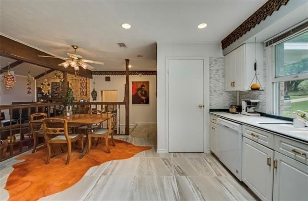 6049 West Red Bird Lane Dallas, TX 75236 - Photo 13 of 34 a kitchen with stainless steel appliances kitchen island granite countertop a sink and cabinets