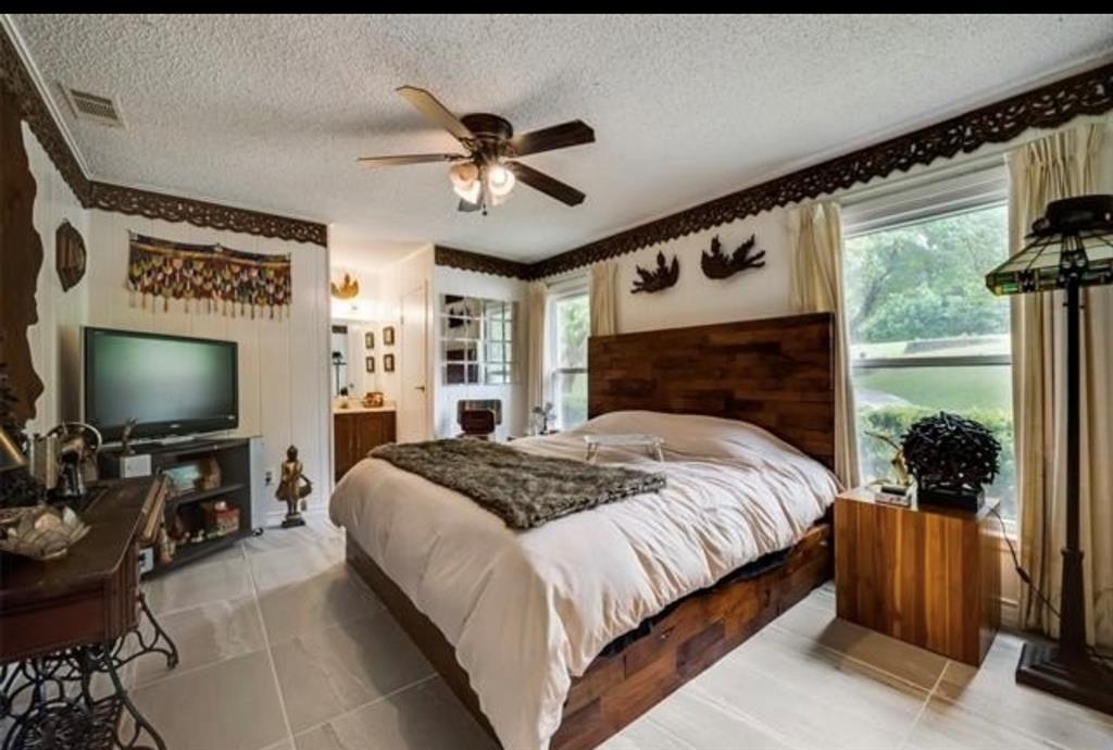 6049 West Red Bird Lane Dallas, TX 75236 - Photo 22 of 34 a bedroom with a bed and a flat screen tv