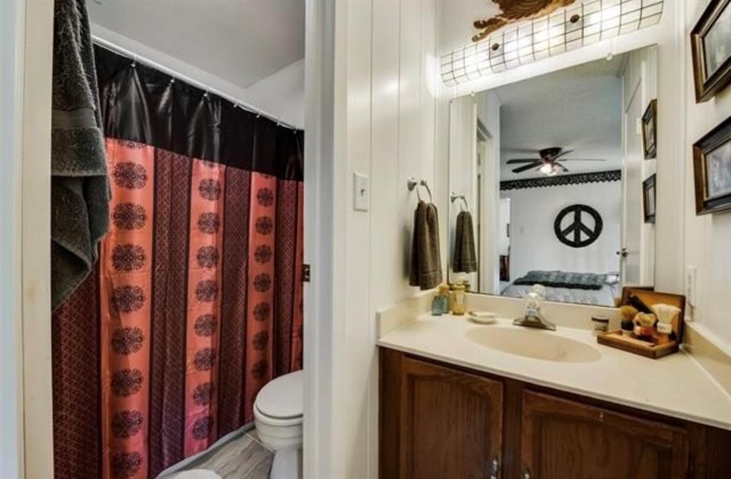 6049 West Red Bird Lane Dallas, TX 75236 - Photo 23 of 34 a bathroom with a sink and a mirror