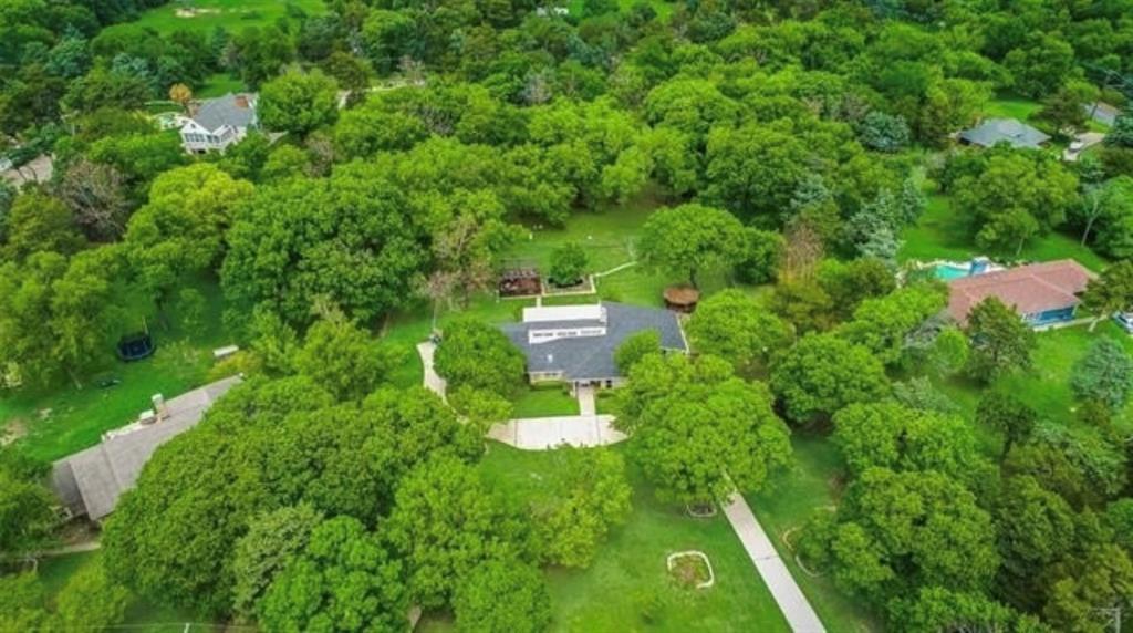 6049 West Red Bird Lane Dallas, TX 75236 - Photo 3 of 34 a lush green forest with lots of trees